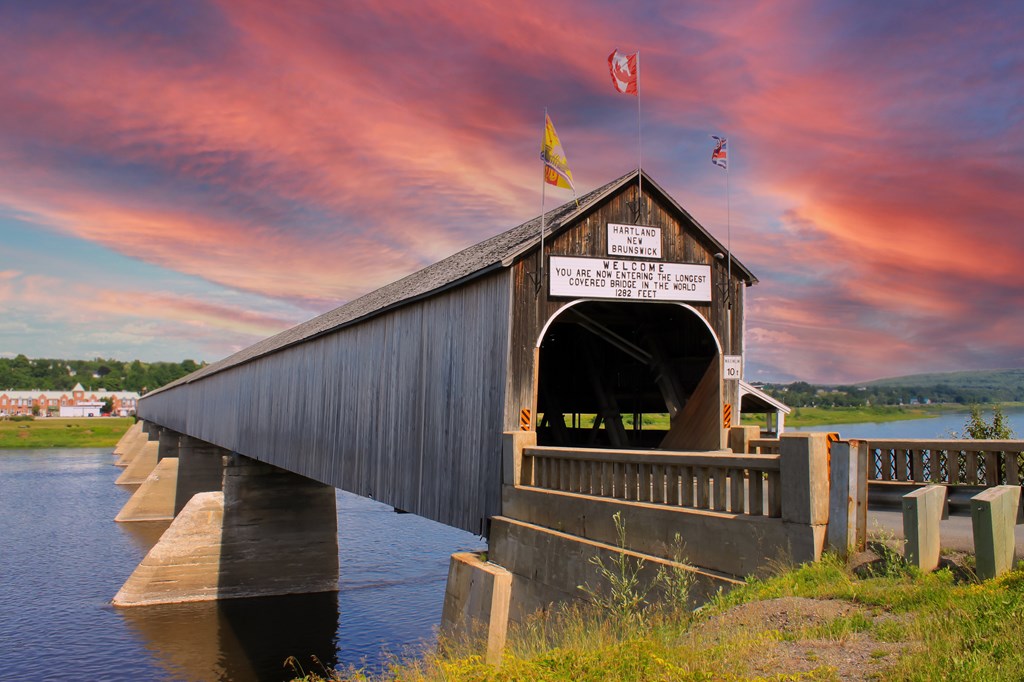 The longest wooden covered bridge in the world located in Hartland, New Brunswick, Atlantic Canada at sunset.