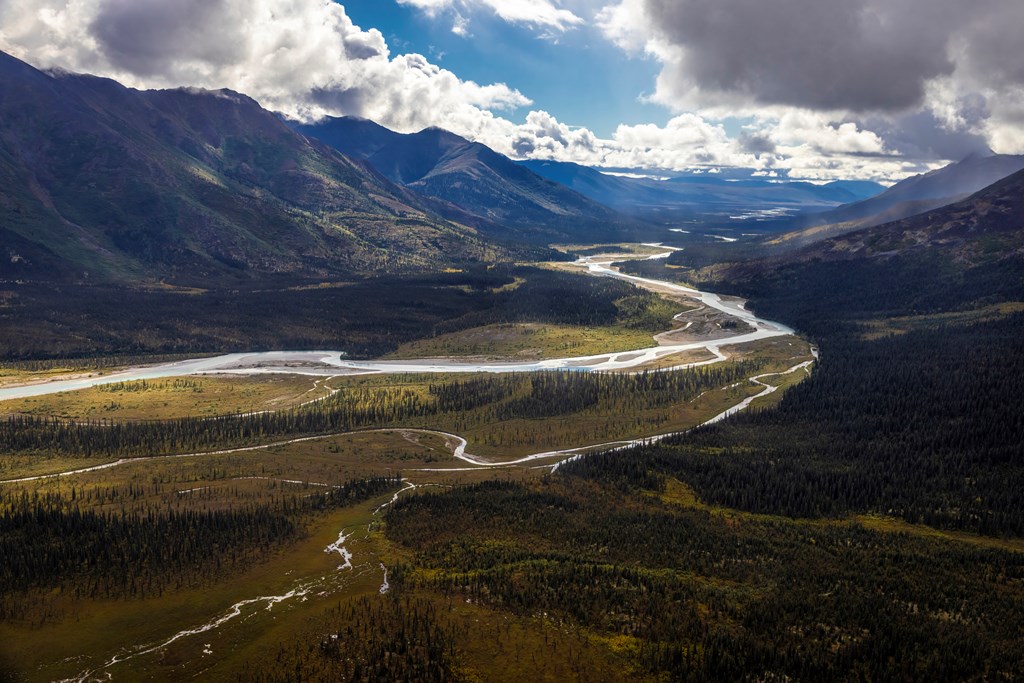 Beautiful landscape view of a river valley surrounded by tall mountains in Kobuk Valley National Park in the arctic of Alaska.