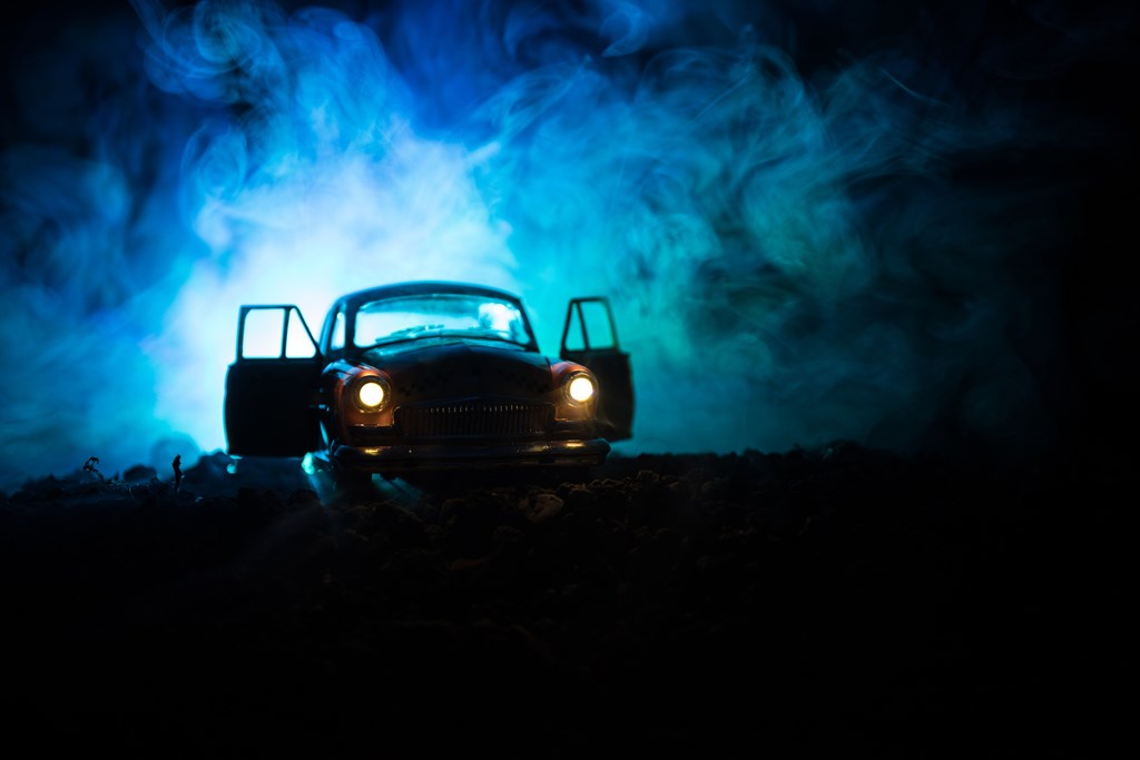Silhouette of an old vintage car in the dark fog sets the scene for The Hook, a creepy story for kids