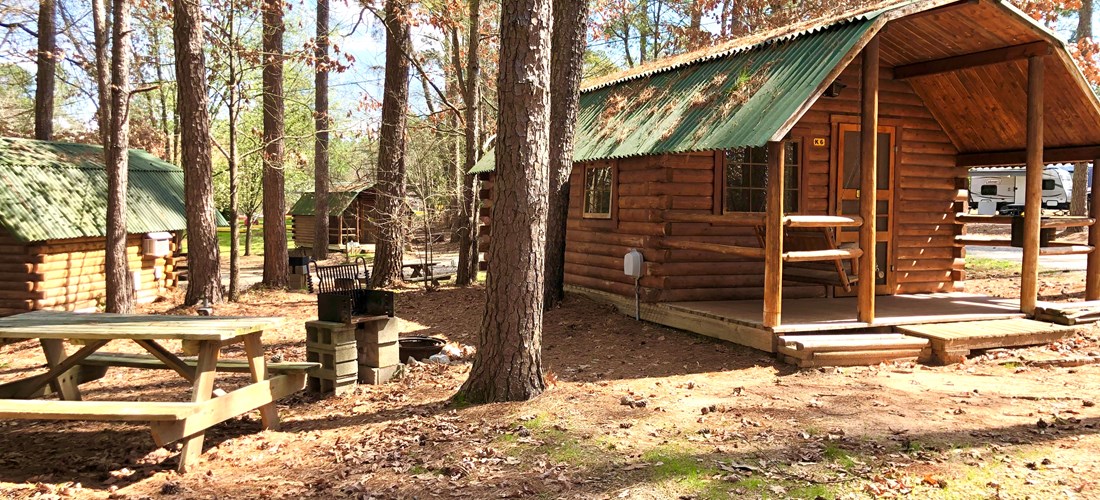Two room camping cabin has a full size bed, mini-refrigerator, and a cable TV in front room and two sets of bunks and a cable TV in the back room. Bring the appropriate linens, etc.