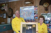 OWNERS DISPLAYING THE AWARDS PLAQUE