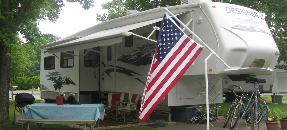 Back-in, full hookup, RV site. These beautiful sites are set among established trees for shaded comfort and relaxation.