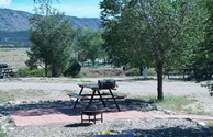 Patio with firepit, grill, table