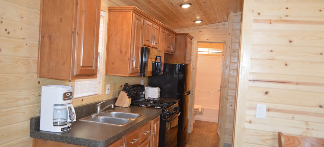 Enjoy the comfort of home with the Deluxe Family Lodges full kitchen!