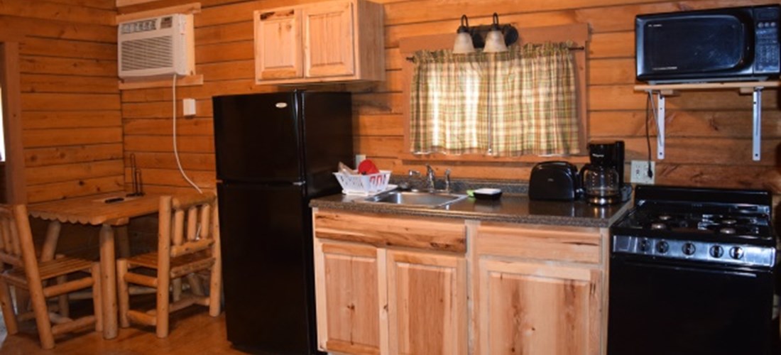 The kitchen area of our Country Cottage is spacious and comes with a full fridge, stove, toaster, microwave, and all of your kitchenware.