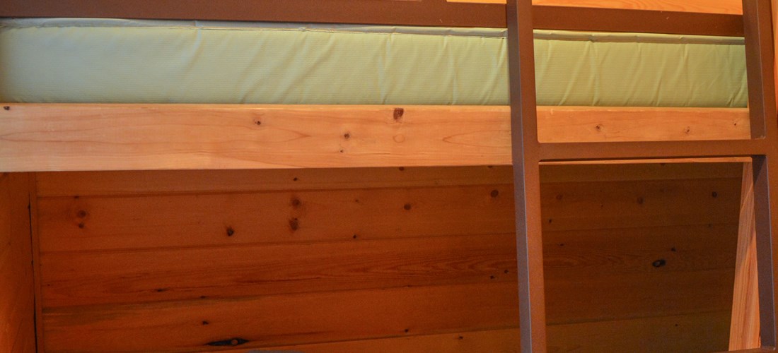 The Deluxe Cabin includes single bunks with linens that are provided.