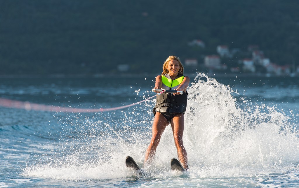 young woman water skiing on a sea