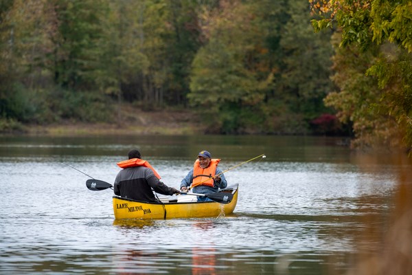 Two men canoeing in the fall at Milton KOA Holiday Wisconsin
