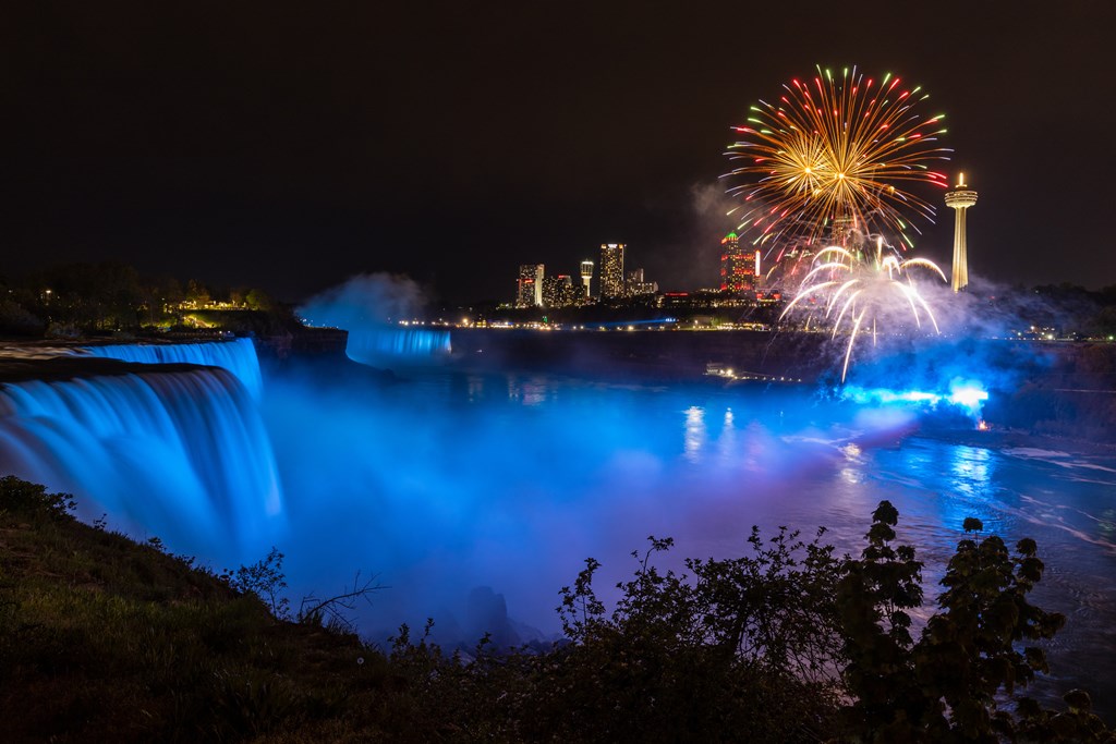 The skyline of Niagara Falls in Canada with fireworks at night