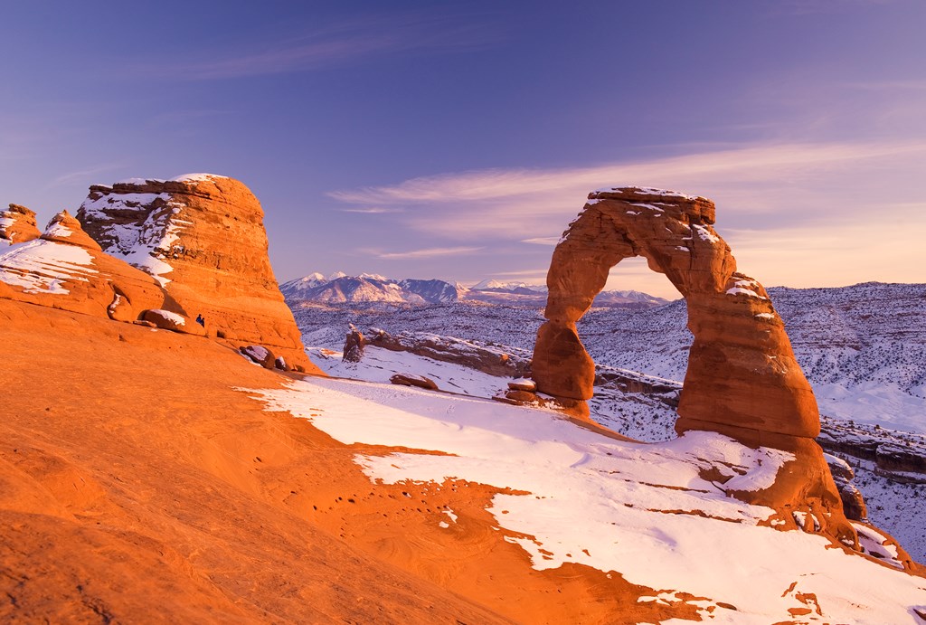 A light snow covers Delicate Arch at Arches National Park.