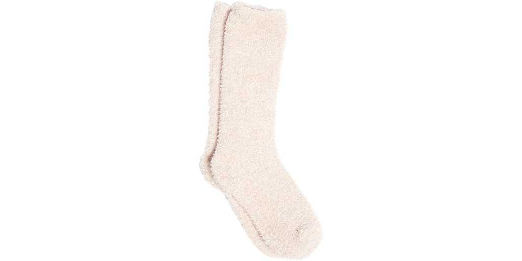 Cream-colored fuzzy socks on a white background.