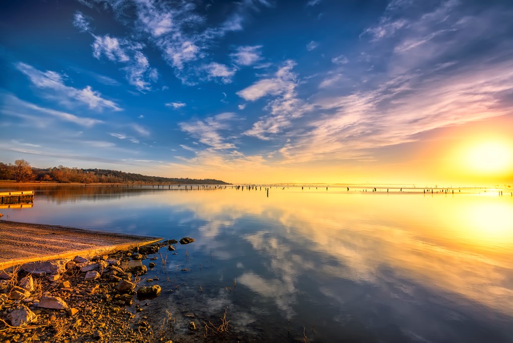 Colorful sunrise over a misty Benbrook Lake in North Texas