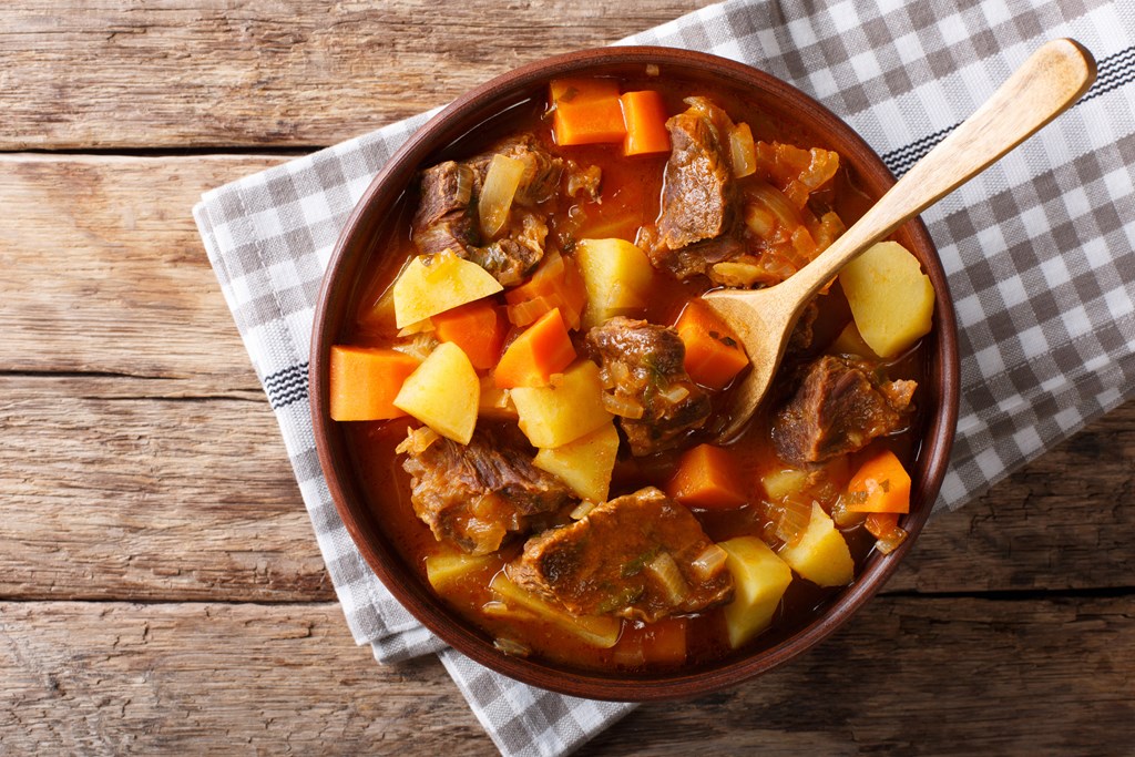 Delicious stew with beef and vegetables in a bowl close-up.