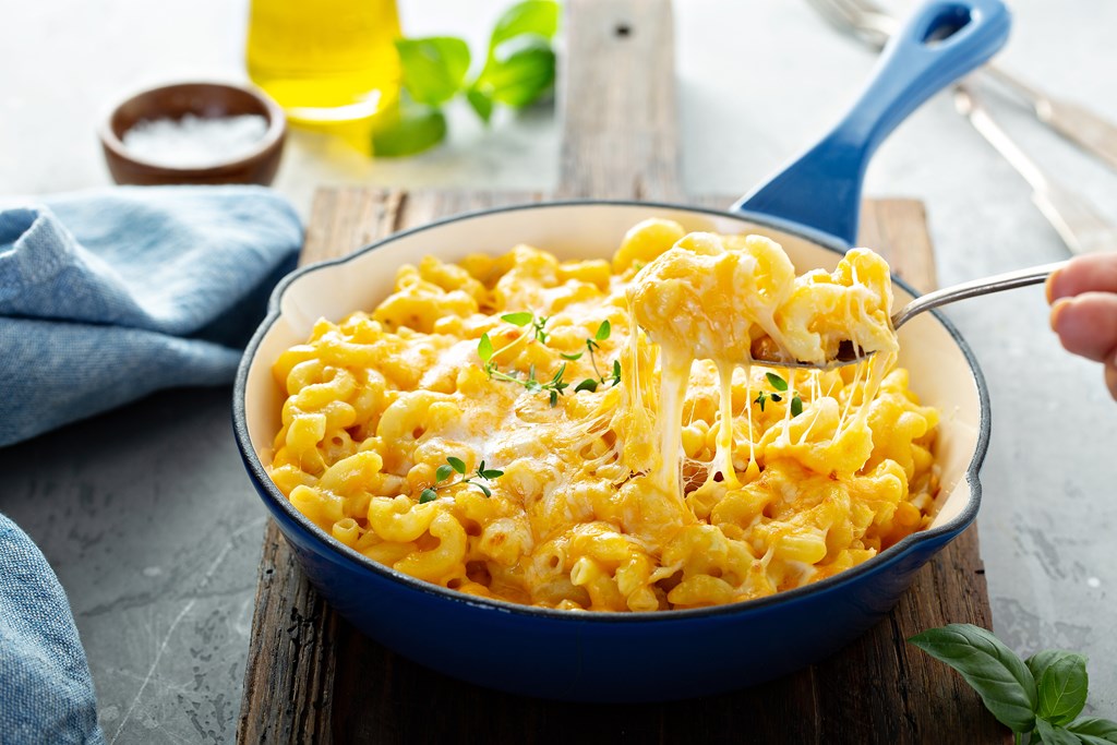 Creamy mac and cheese in a blue enamel cast iron skillet.