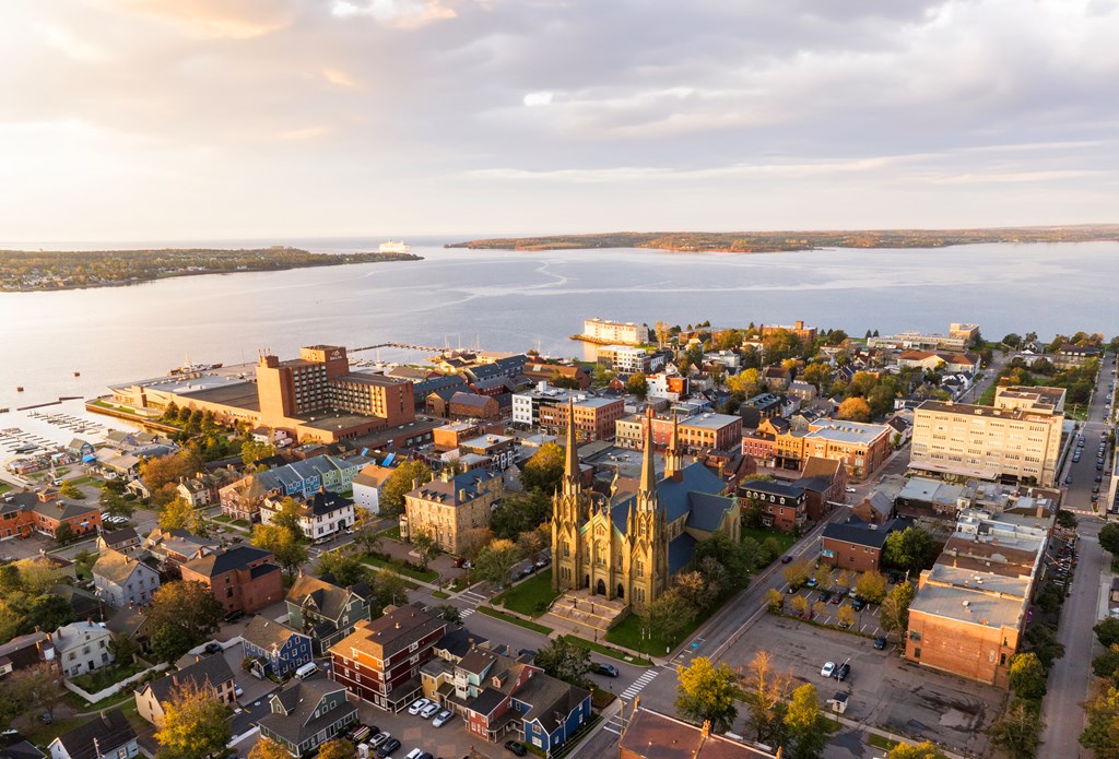 Aerial drone photograph of downtown Charlottetown looking towards the ocean at sunrise.
