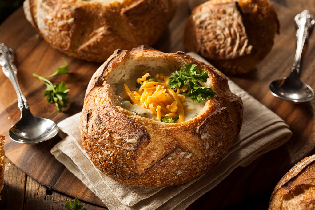 Homemade cheese soup in a crusty bread bowl.