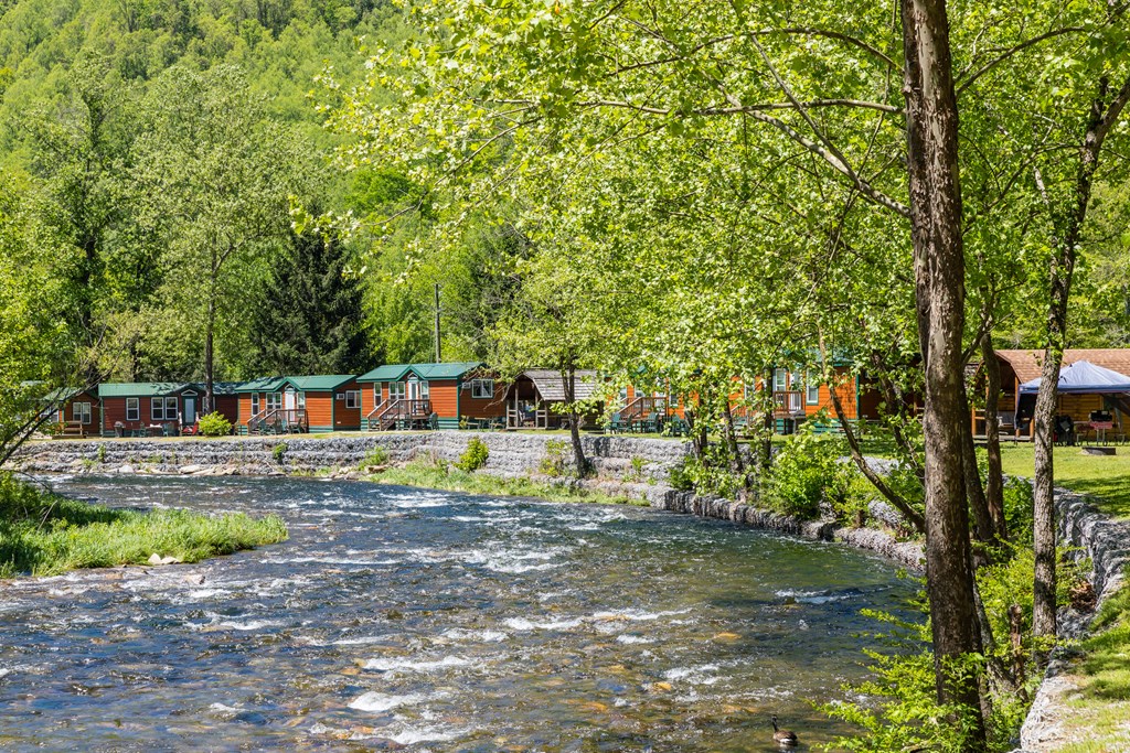 Cozy cabins at Cherokee KOA campground overlooking a river.