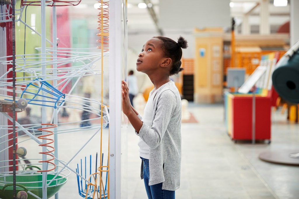 Young girl looking at a science exhibit, close up