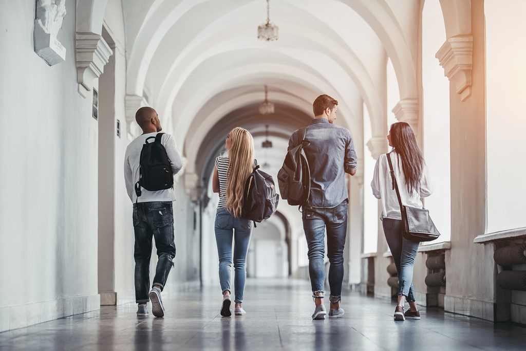 Students walking in university hall.