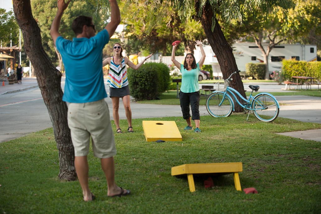 Group playing cornhole on a campground.