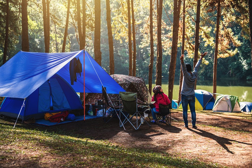 Couple camping by a lake.