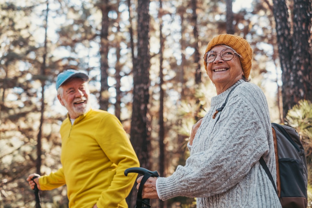 Senior couple taking a hiking and smiling.