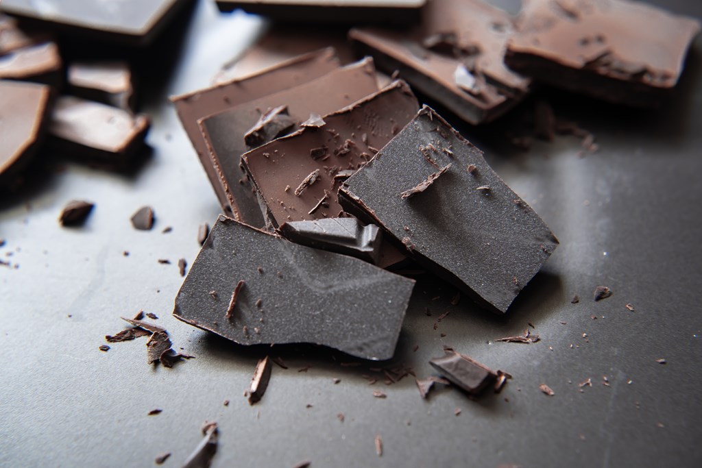 Pieces of chocolate on a black dish.