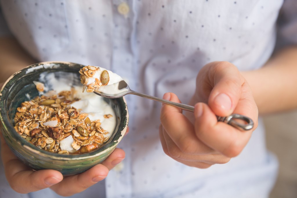 Close up of a bowl of granola with yogurt.