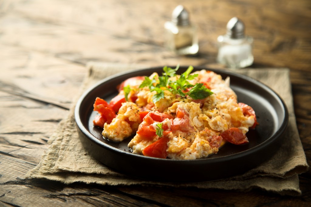 Scrambled eggs with tomato salsa.