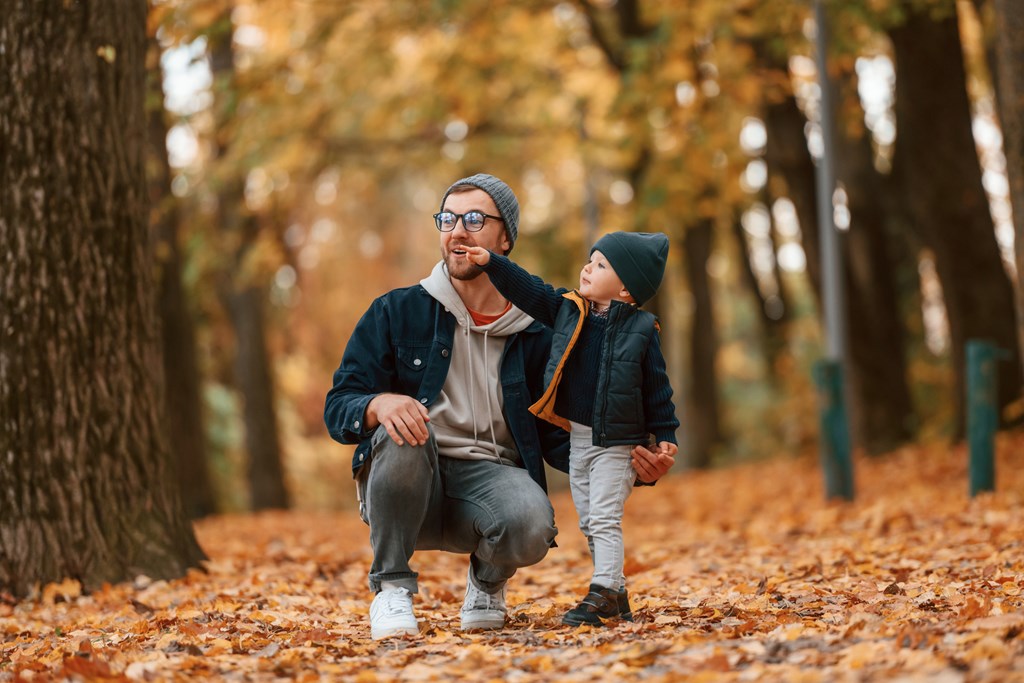 Father and young sun enjoying the outdoors on a fall day.