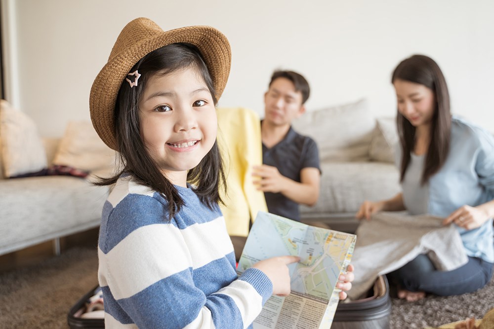 Happy family is preparing for travel at home.