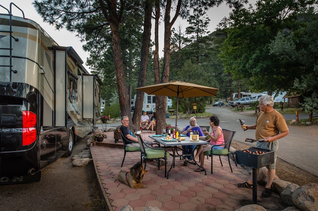 A family enjoys the patio on an RV site.