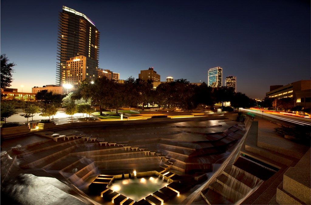 Nighttime view of downtown Ft Worth, Texas with the famous Water Garden in the foreground.