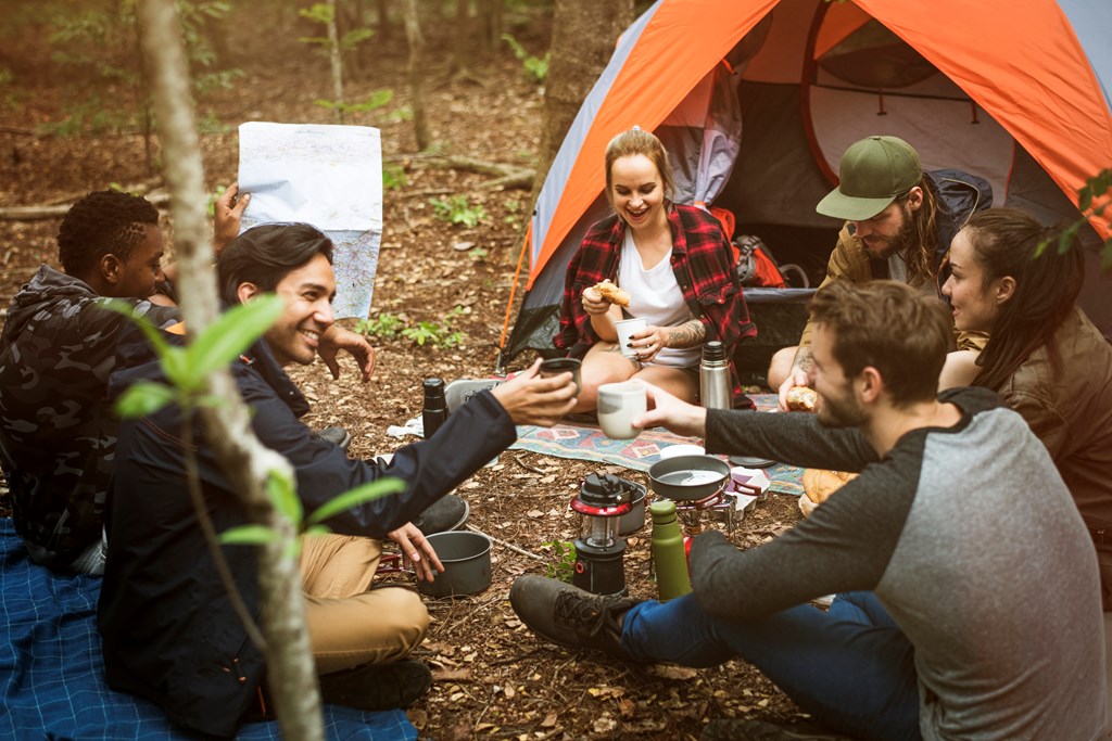 Friends camping in the forest together.