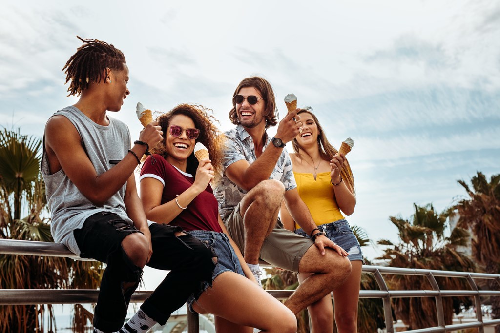 Friends enjoying ice cream cones during a summer outing