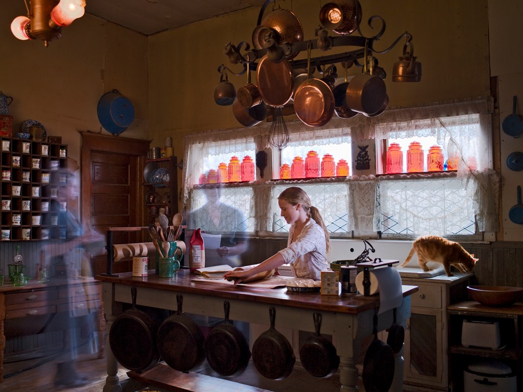 Young girl making dough in kitchen while ghost of her grandmother looks on, setting the scene for this kids ghost story