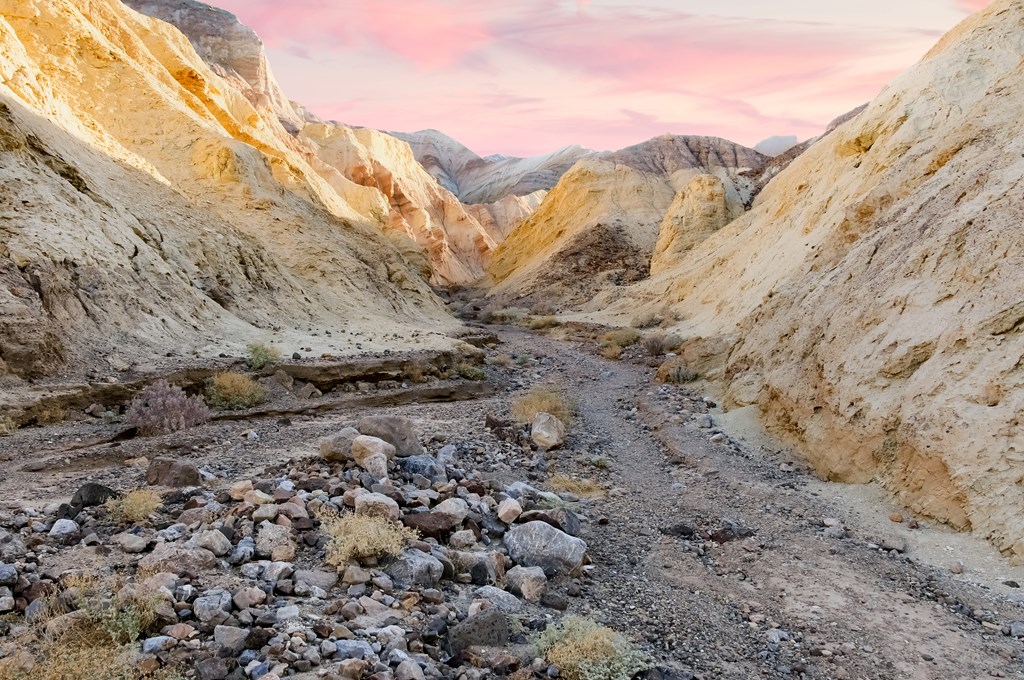 Pink morning sunlight over Golden Canyon Interpretive Trail in Death Valley National Park.