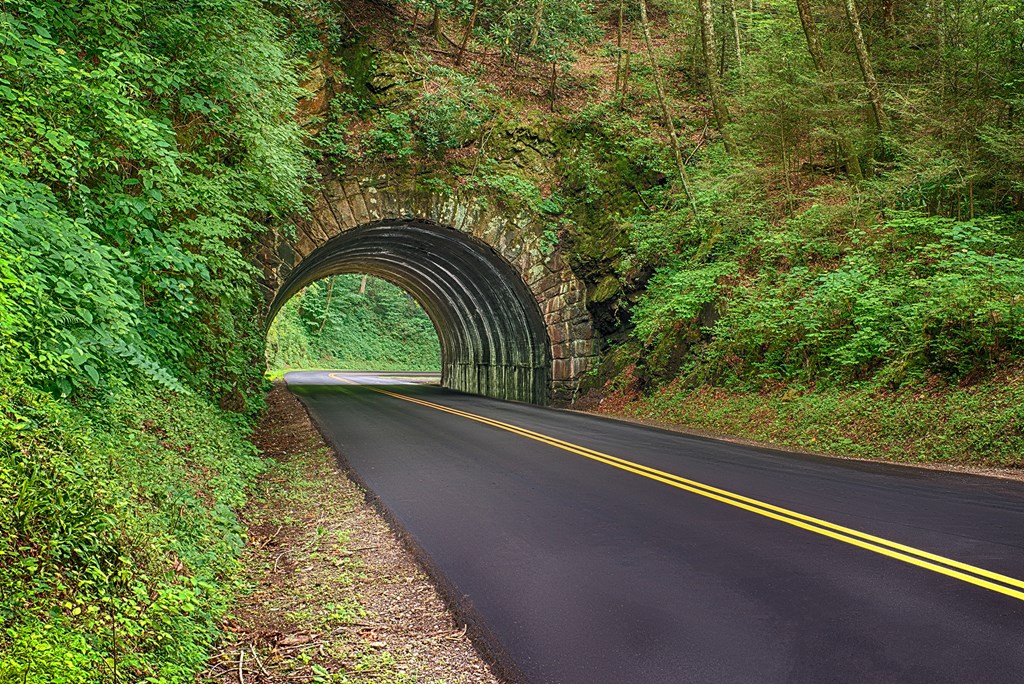 Horizontal shot of a new blacktop road going through a tunnel in the Smoky Mountains National Park in Tennessee.