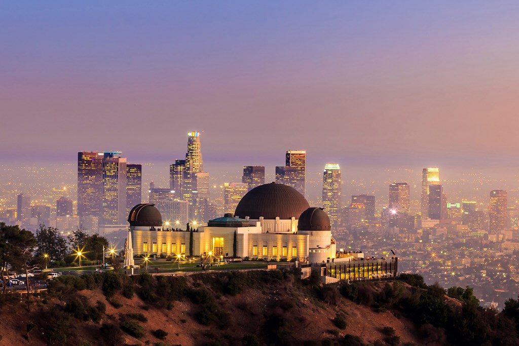 The Griffith Observatory and Los Angeles city skyline at twilight.