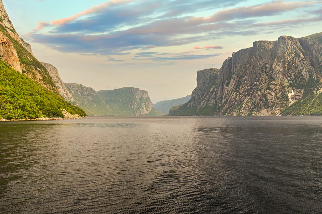 Admiring the beautiful view from the tour boat at the fjords of the Western brook pond in Gros Morne National Park, Newfoundland and Labrador, Canada.