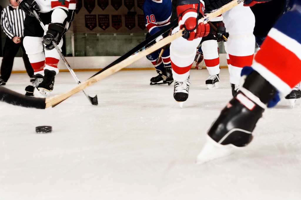 A low angle view of two teams playing hockey.