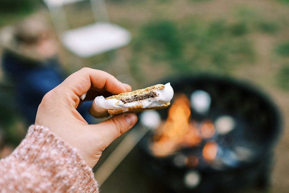 Child holding a s'more.