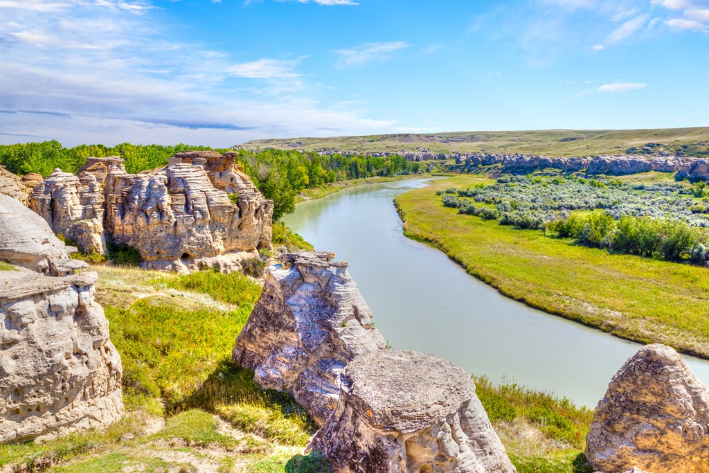 Unique Hoodoo rocks straddle the Milk River at Writing-on-Stone Provincial Park in Alberta, Canada. The area contains the largest concentration of First Nation petroglyphs (rock carvings) and pictographs (rock paintings) on the great plains of North America.