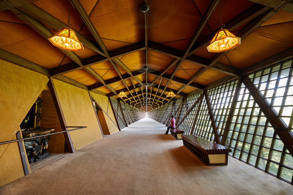 A long hallway made of wood and glass.