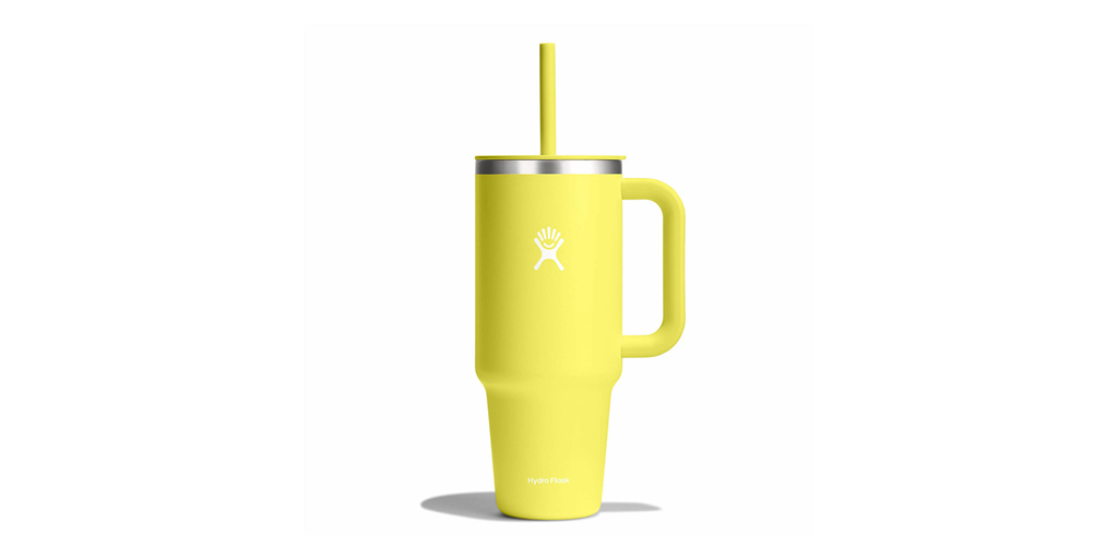 A bright yellow tumbler with a straw on a white background.