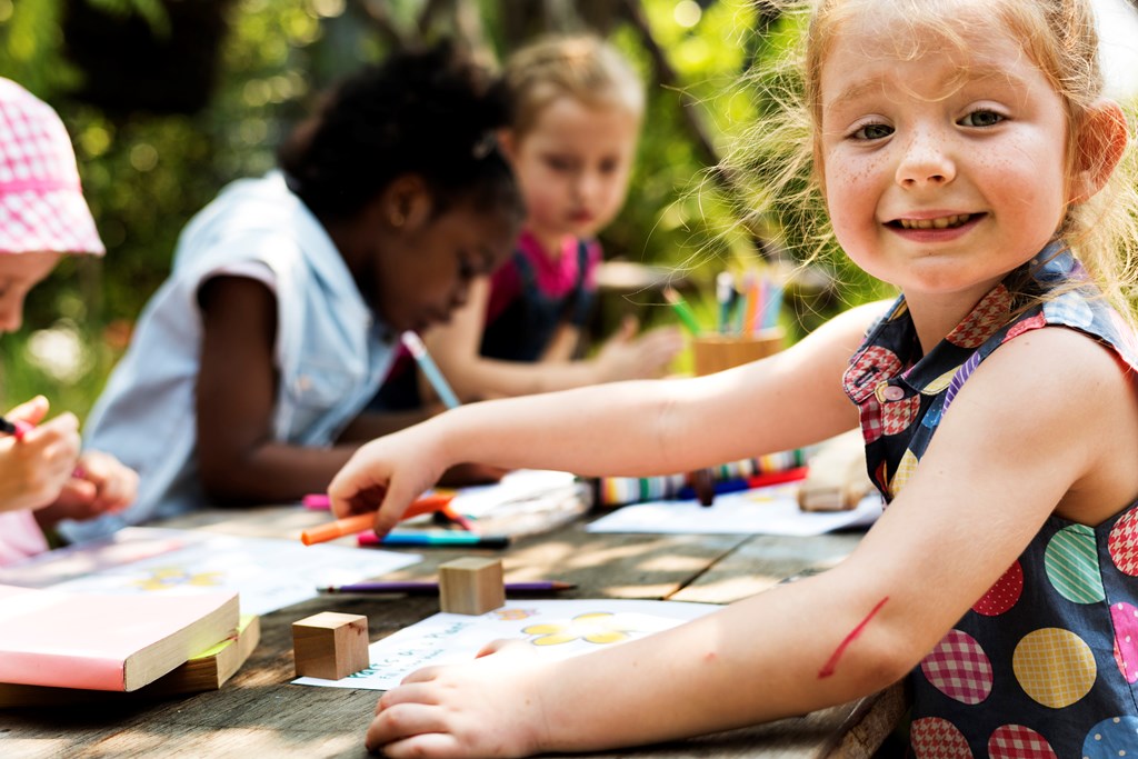 Group of children drawing outdoors.