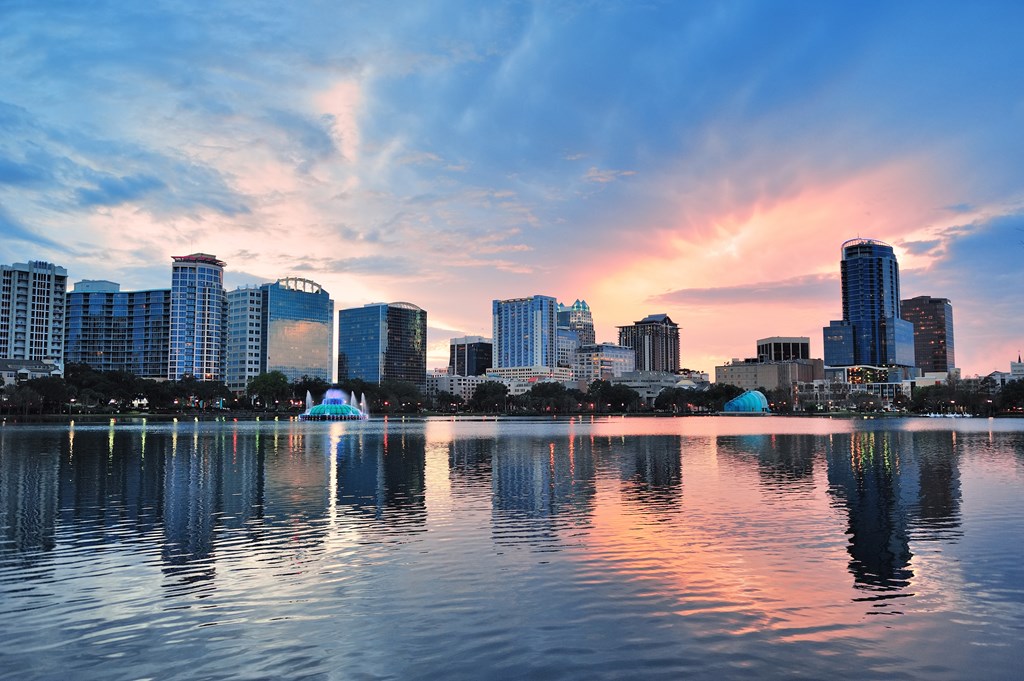 View of downtown Orlando at sunset across Lake Eola.