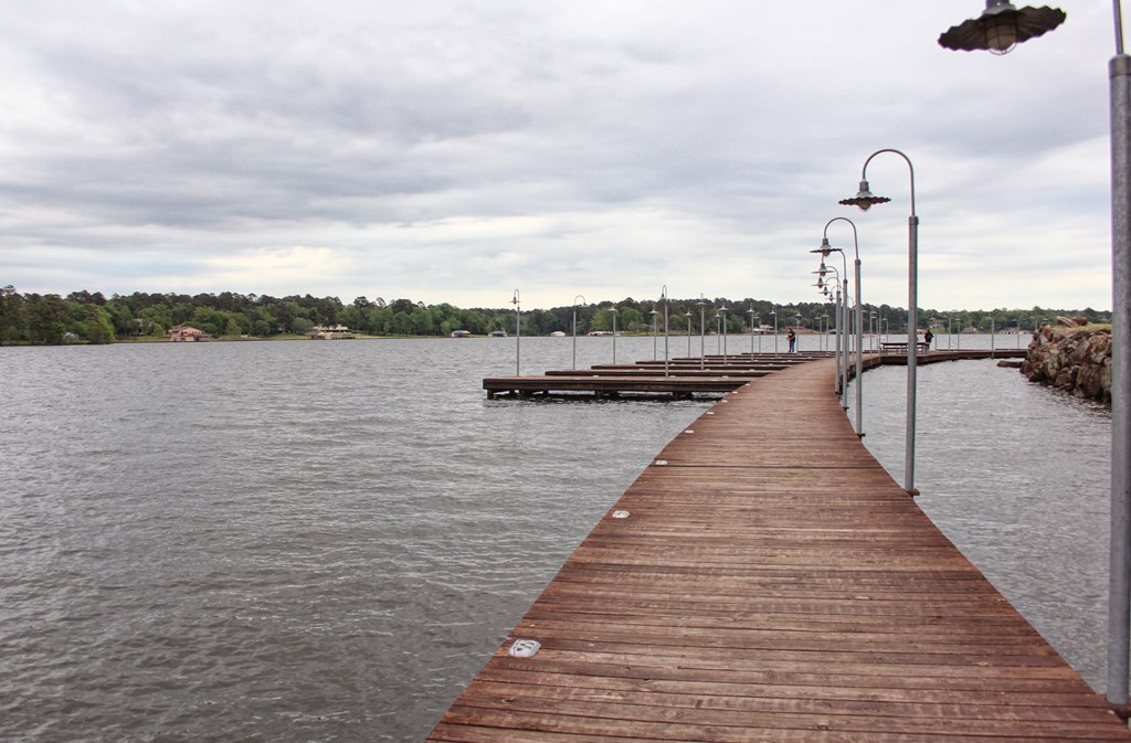 A wood pier at Lake Tyler on a cloudy day.