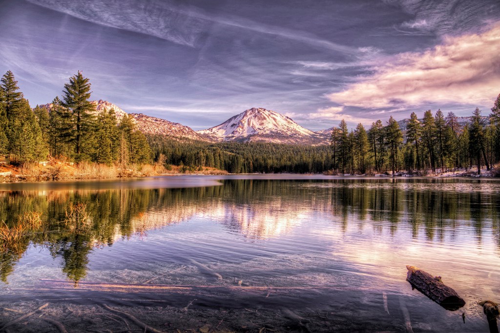 Lassen Peak, in the Lassen Volcanic National Park, shows signs of the first winter snow. In the foreground is Manzanita lake, which is a fly fisherman paradise.