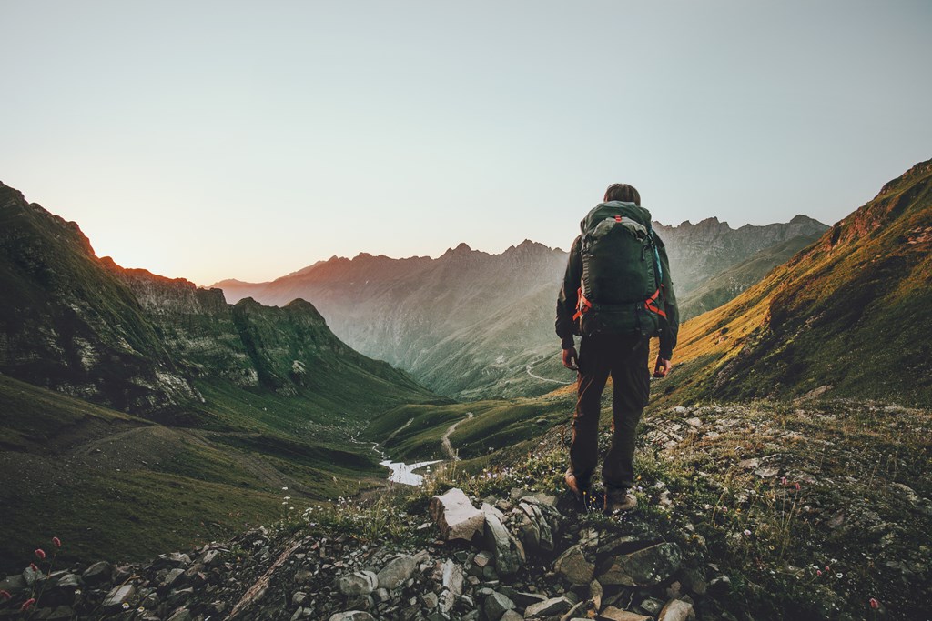 Man hiking at sunset in the mountains.